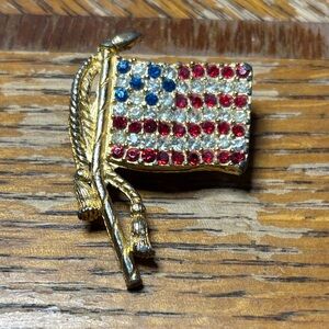vintage Rafaelian rhinestone American flag brooch pin in gold tone.